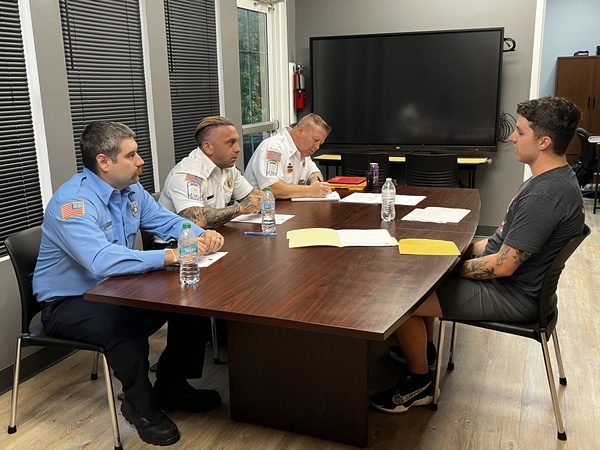 Chief Joshua Anderson, Captain Andrew Ulmer and firefighter Alec Wogoman interview a recruit academy applicant.