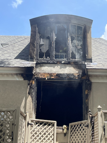 Fire damage to a second floor window of a home