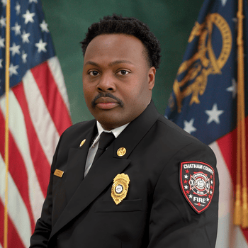 Captain John-William Farrell professional photo in front of the American flag