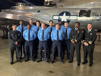 CCFD Fire academy graduates posing in front of a B-52 bomber plane