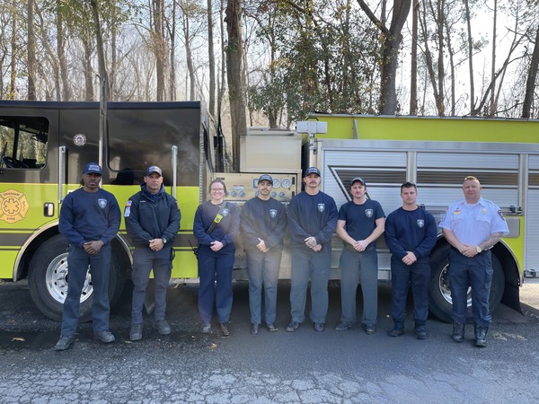 Seven members of the Chatham Fire Department stand in front of a fire engine after completing Instructor 1 certification