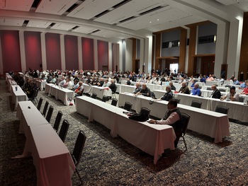a grand ball room full of attendees of a Fire service conference sitting at tables