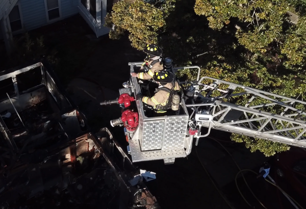 Two firefighters in an Aeriel bucket