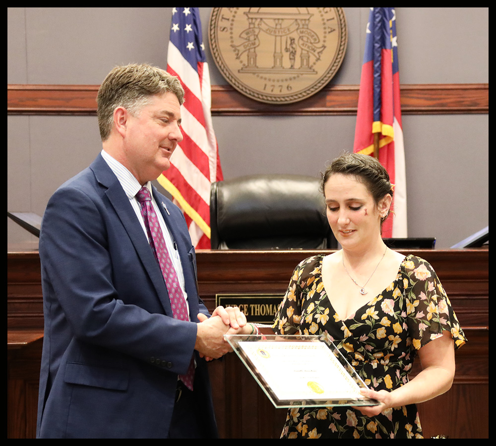 Anchor Court graduate Danielle Beauchane receives her certificate from Presiding Judge Thomas Cole