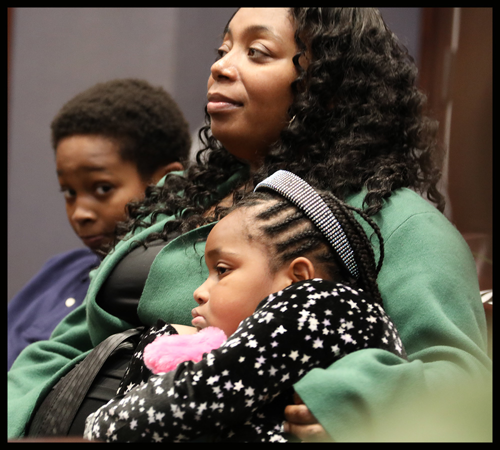 Anchor Court graduate Decolajabowl Pierre cuddles her children during graduation ceremony