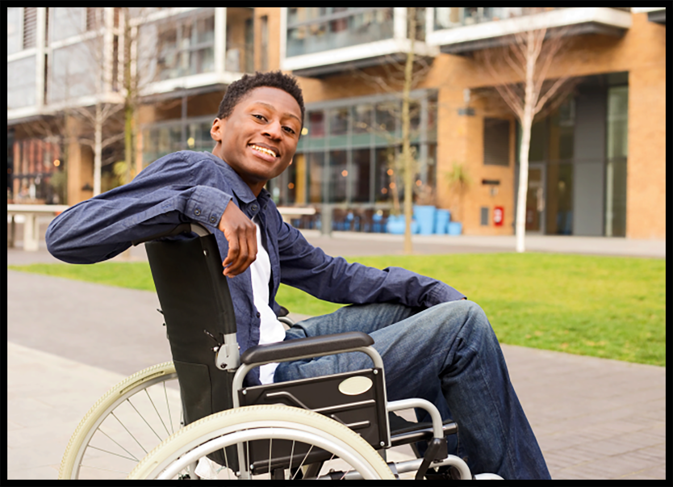 young man in wheelchair smiling at viewer