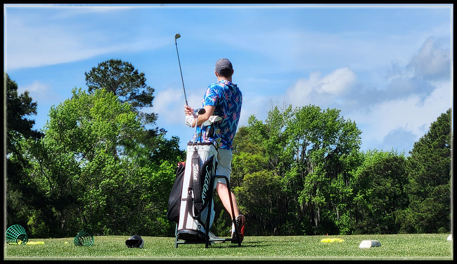 Golfer makes a perfect swing on a perfect day